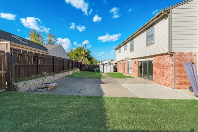 view of yard with a shed and a patio area