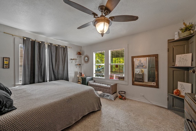 carpeted bedroom featuring a textured ceiling and ceiling fan