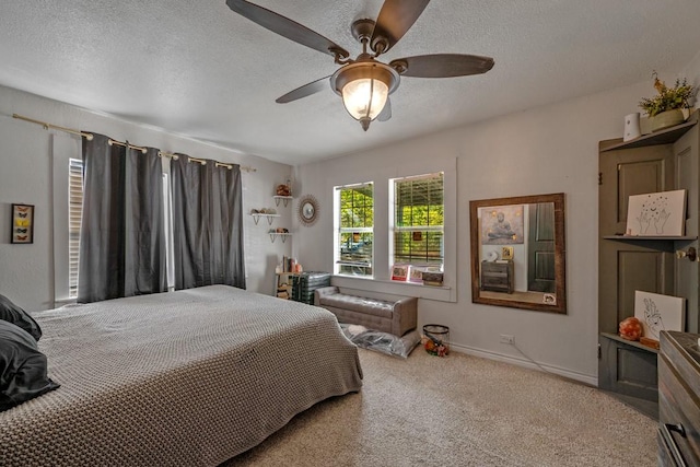 504 E Monterey St, Denison, TX 75021 - bedroom featuring carpet floors, a textured ceiling, baseboards, and ceiling fan