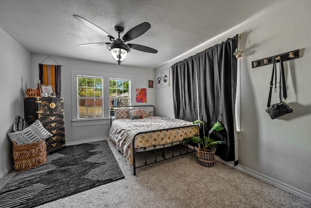 bedroom with ceiling fan, a textured ceiling, and carpet floors