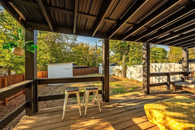 wooden terrace with a shed