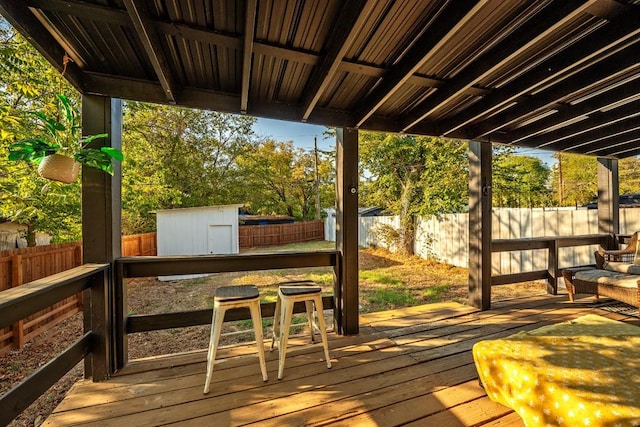 504 E Monterey St, Denison, TX 75021 - wooden terrace with a fenced backyard, an outbuilding, and a storage shed