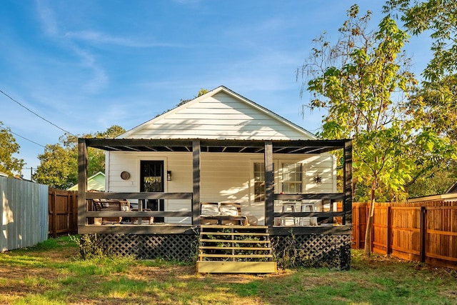 back of house with a wooden deck