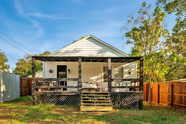 504 E Monterey St, Denison, TX 75021 - rear view of house with covered porch and fence