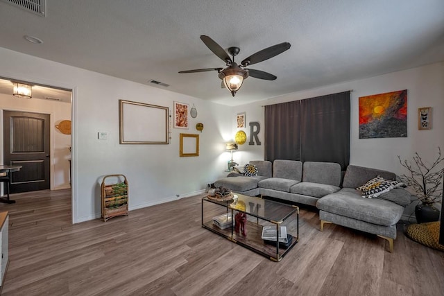 504 E Monterey St, Denison, TX 75021 - living room with wood finished floors, baseboards, a ceiling fan, and visible vents