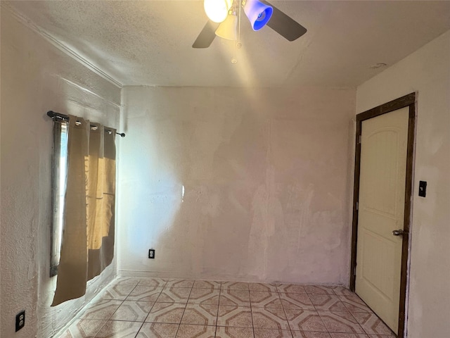 unfurnished room with a textured ceiling and ceiling fan