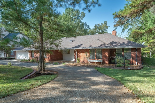 single story home with a front yard and a garage