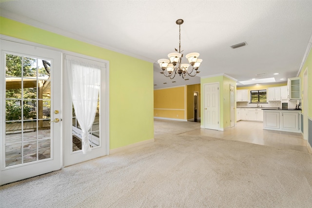 interior space with crown molding, light carpet, and an inviting chandelier