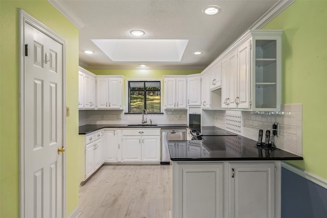 kitchen featuring stainless steel dishwasher, sink, white cabinets, and crown molding