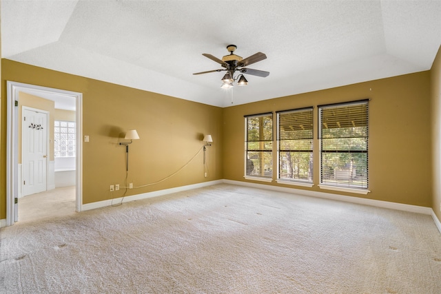 unfurnished room with ceiling fan, a textured ceiling, lofted ceiling, and light colored carpet