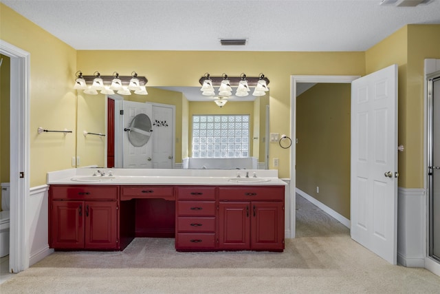 bathroom with vanity, an enclosed shower, a textured ceiling, and toilet