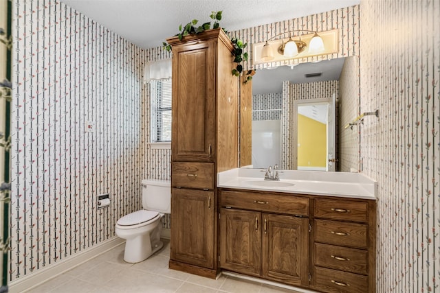 bathroom with vanity, a textured ceiling, toilet, and tile patterned floors