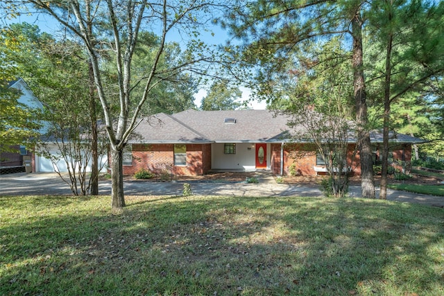 single story home featuring a front yard and a garage