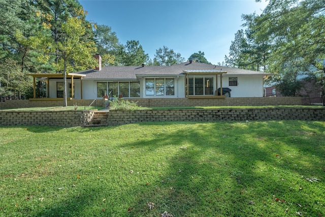 back of house with a lawn