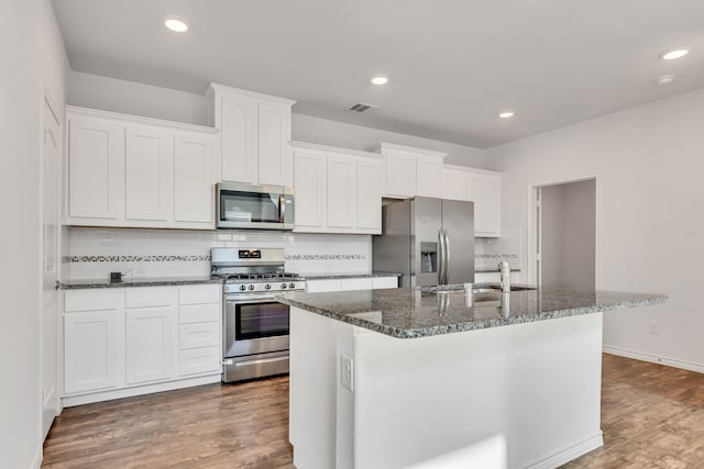 kitchen with white cabinets, stainless steel appliances, and dark wood-type flooring