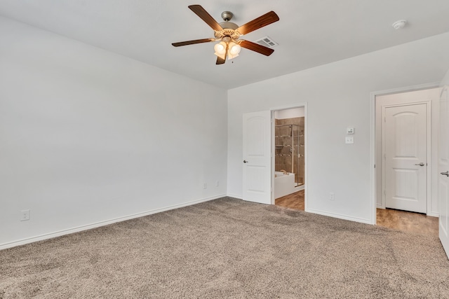 unfurnished bedroom with connected bathroom, carpet floors, and ceiling fan