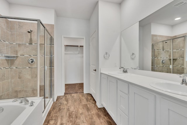 bathroom with vanity, shower with separate bathtub, and hardwood / wood-style flooring