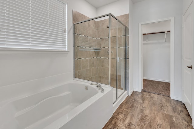 bathroom featuring separate shower and tub and wood-type flooring