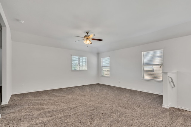 carpeted spare room with ceiling fan