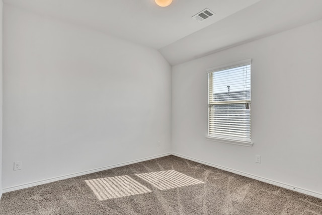 spare room with carpet and lofted ceiling