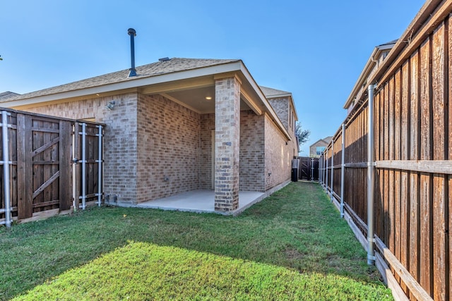 rear view of house featuring a patio and a lawn