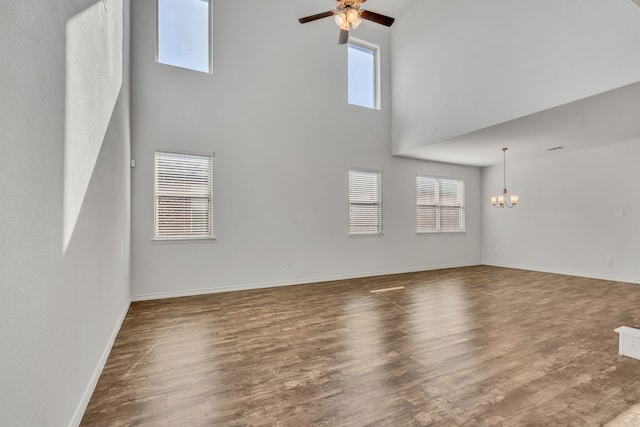 unfurnished living room with hardwood / wood-style floors, a high ceiling, and plenty of natural light