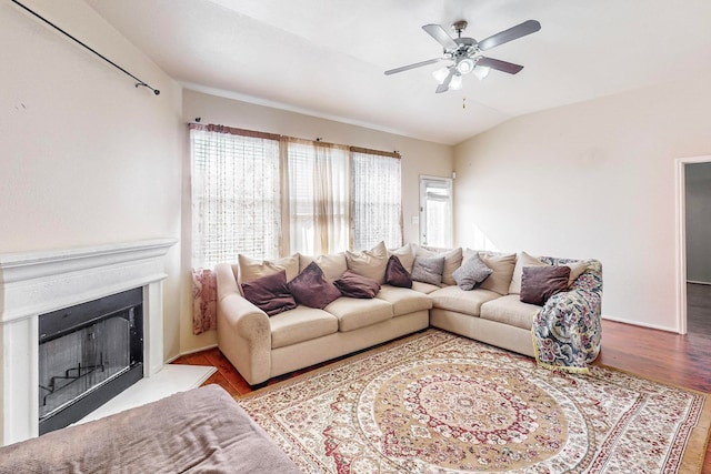 living room featuring hardwood / wood-style floors, ceiling fan, and vaulted ceiling