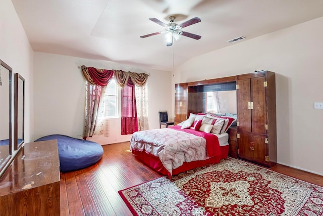 bedroom with ceiling fan, lofted ceiling, and hardwood / wood-style floors