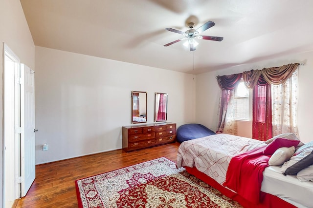 bedroom with ceiling fan and dark hardwood / wood-style floors