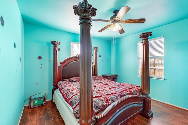 bedroom with multiple windows, dark hardwood / wood-style floors, and ceiling fan