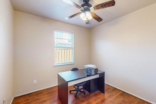 home office with dark hardwood / wood-style floors and ceiling fan