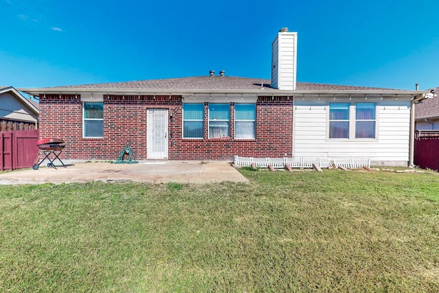 back of property featuring a patio and a yard