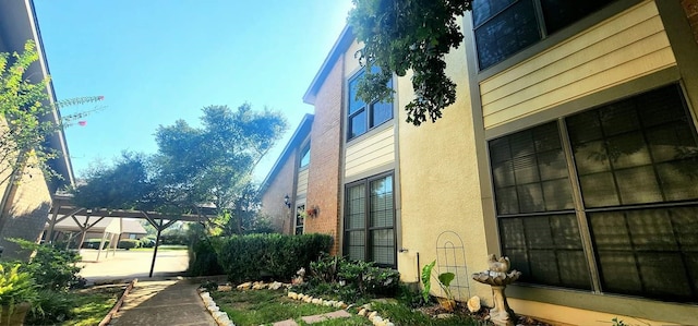 view of side of property featuring stucco siding