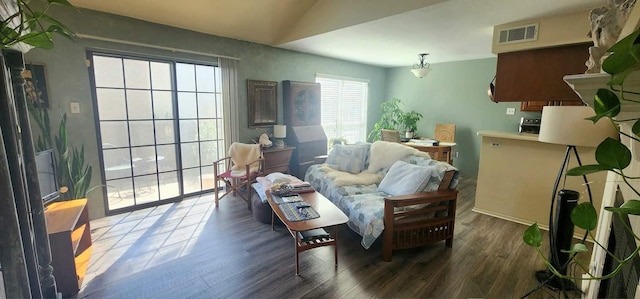 living area with dark hardwood / wood-style flooring and vaulted ceiling