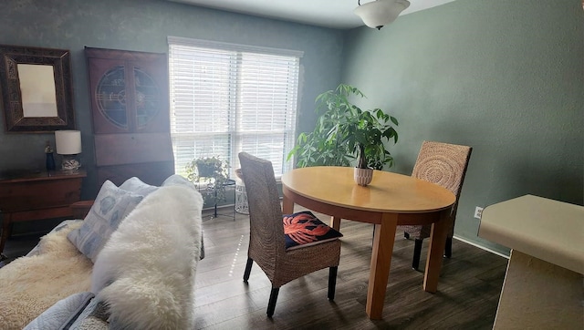 dining area featuring baseboards and wood finished floors