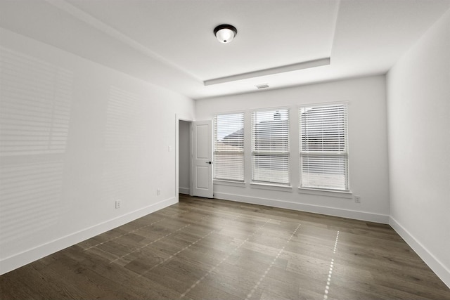 spare room featuring a raised ceiling