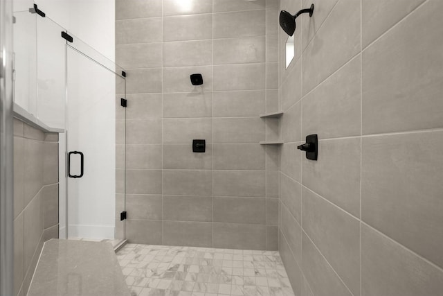 bathroom featuring a shower with door