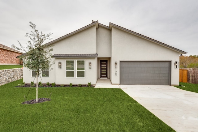 view of front of property featuring a front yard and a garage