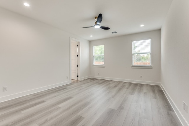 spare room featuring ceiling fan and light hardwood / wood-style flooring