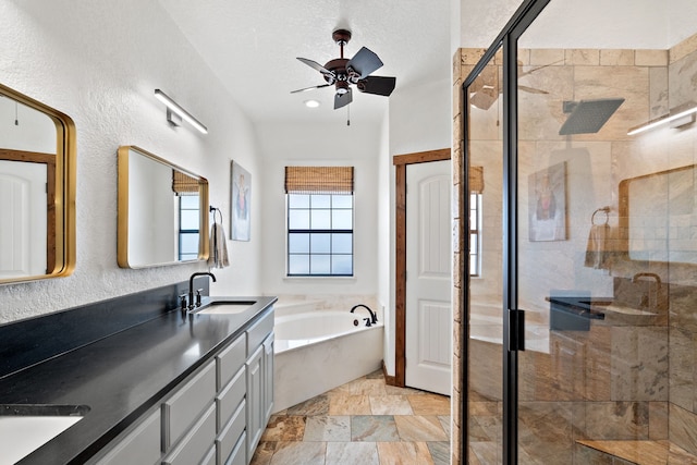 bathroom featuring vanity, a textured ceiling, plus walk in shower, and ceiling fan