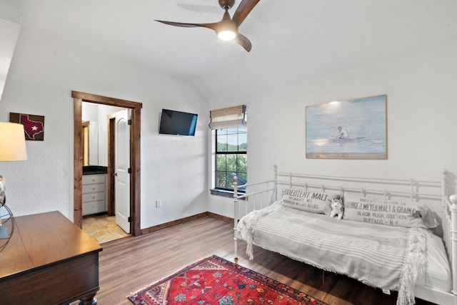 bedroom featuring light hardwood / wood-style floors, vaulted ceiling, and ceiling fan