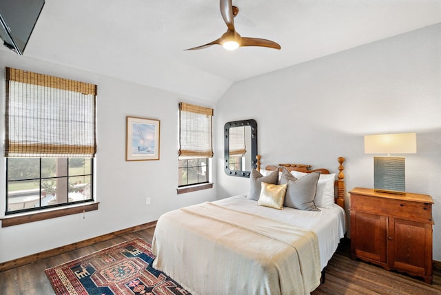 bedroom with multiple windows, ceiling fan, lofted ceiling, and dark hardwood / wood-style flooring