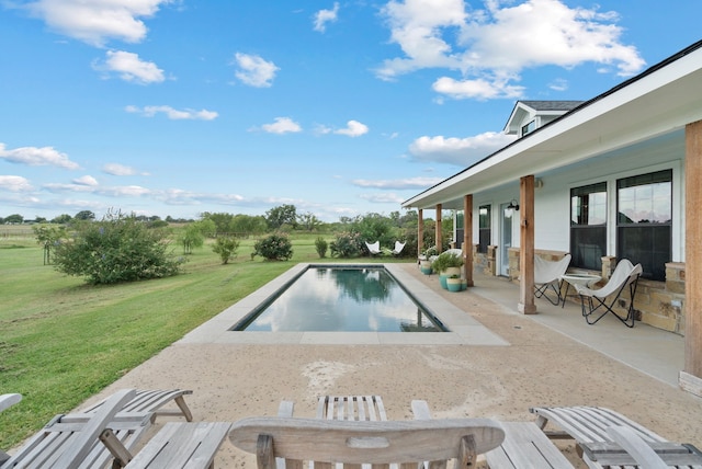 view of swimming pool with a patio area and a lawn