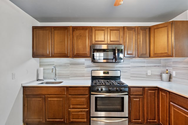 kitchen featuring sink, appliances with stainless steel finishes, and backsplash