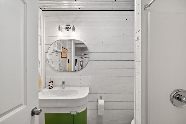 bathroom featuring wooden walls