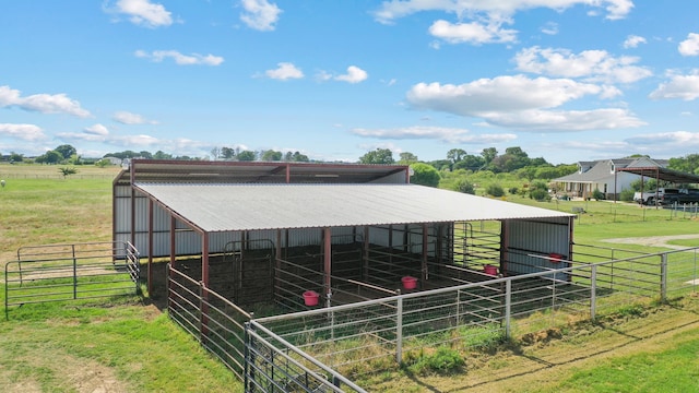 view of horse barn with a rural view