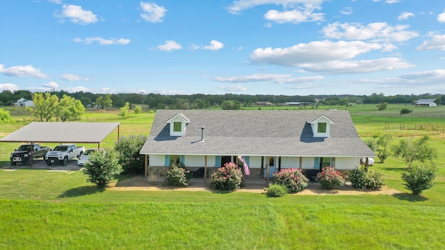 view of front of house with a porch, a rural view, a front lawn, and a carport