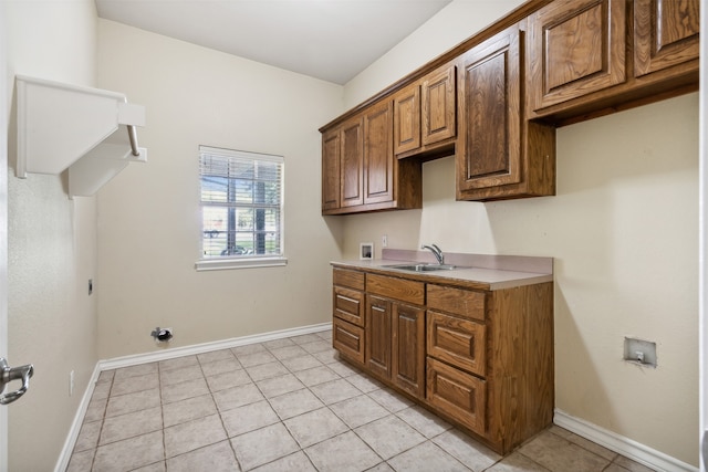 kitchen featuring light tile patterned floors and sink