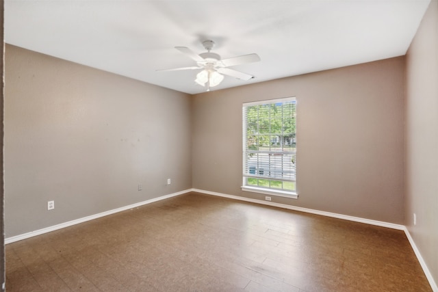 unfurnished room with ceiling fan and dark hardwood / wood-style floors