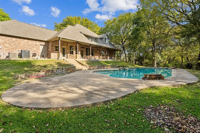 view of swimming pool with cooling unit, a patio, and a lawn